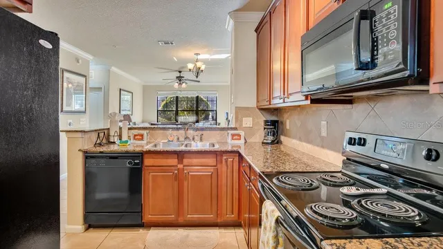a kitchen with stainless steel appliances granite countertop a stove and a sink