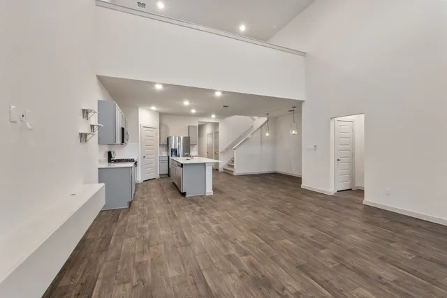 a view of a kitchen with furniture and wooden floor