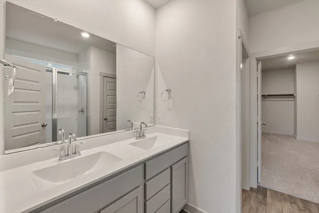 a bathroom with a double vanity sink mirror and double