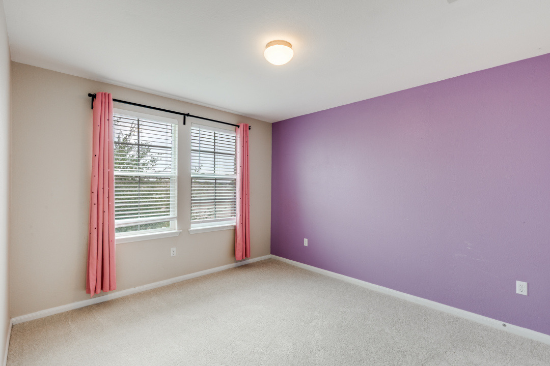 13708 Sierra Wind Lane Elgin, TX 78621 - Photo 15 of 19 Carpeted secondary bedroom, lots of light