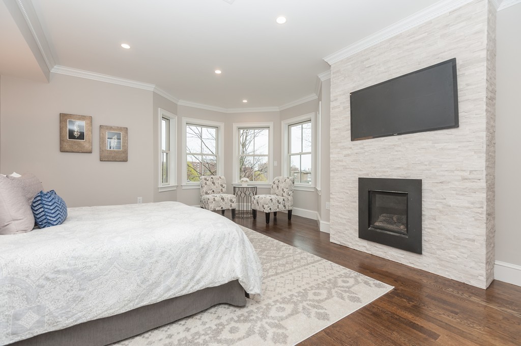 33 Winthrop Road, Unit 1 Brookline, MA 02445 - Photo 9 of 19 a bedroom with a bed and a flat screen tv