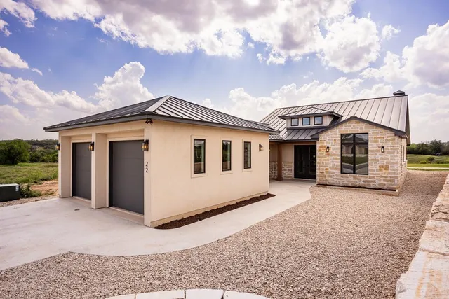 a view of white house with a yard