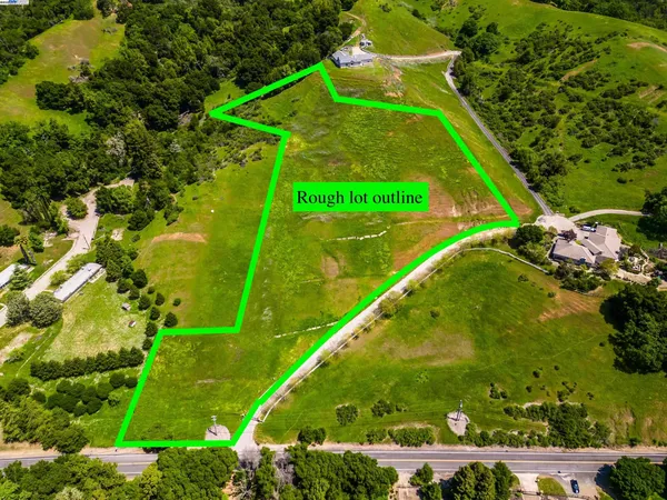 a view of a field with an ocean view