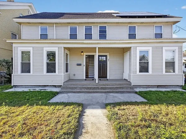 a front view of a house with a yard