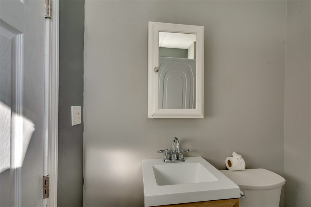 96 Pleasant Street, Unit 96 Ashland, MA 01721 - Photo 11 of 20 a bathroom with a toilet sink and mirror