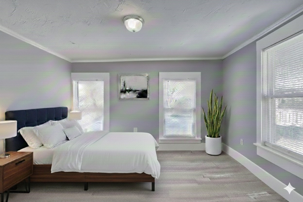 96 Pleasant Street, Unit 96 Ashland, MA 01721 - Photo 14 of 20 a bedroom with a large bed and a potted plant