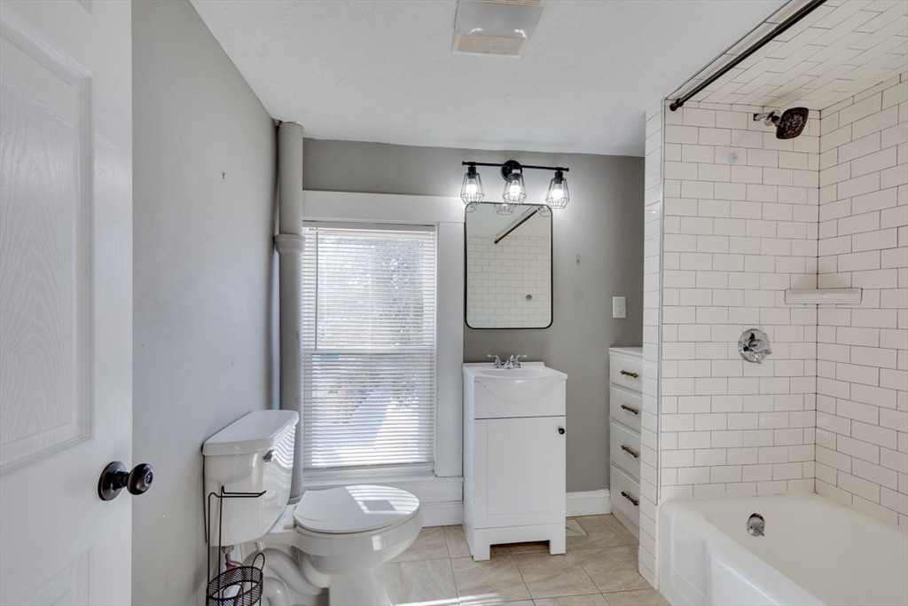 96 Pleasant Street, Unit 96 Ashland, MA 01721 - Photo 17 of 20 a bathroom with a toilet a sink and shower