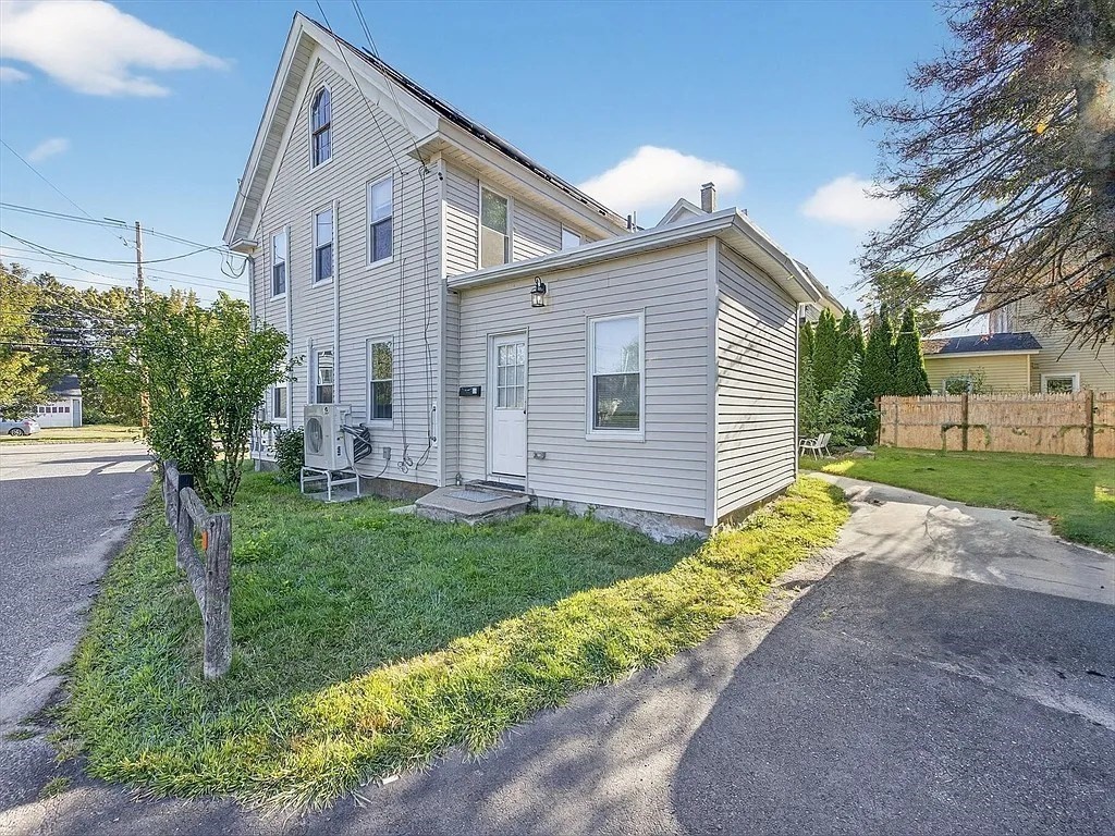 96 Pleasant Street, Unit 96 Ashland, MA 01721 - Photo 19 of 20 a front view of a house with a yard and garage