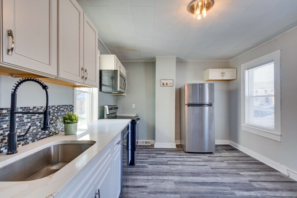 96 Pleasant Street, Unit 96 Ashland, MA 01721 - Photo 2 of 20 a kitchen with stainless steel appliances granite countertop a refrigerator and a sink