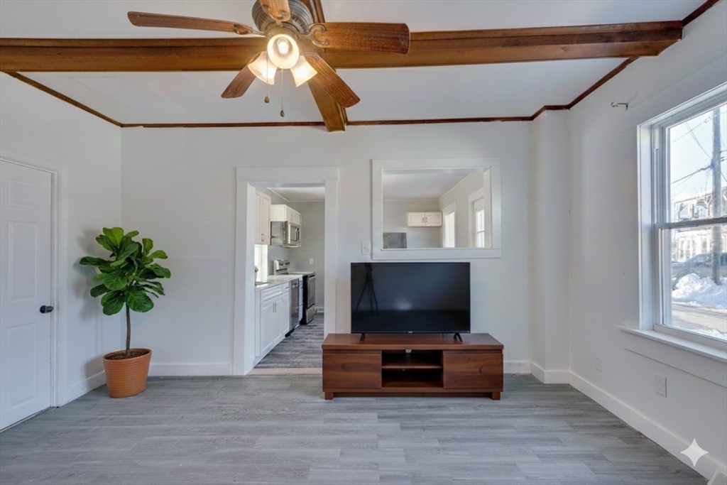 96 Pleasant Street, Unit 96 Ashland, MA 01721 - Photo 6 of 20 a living room with furniture and a flat screen tv