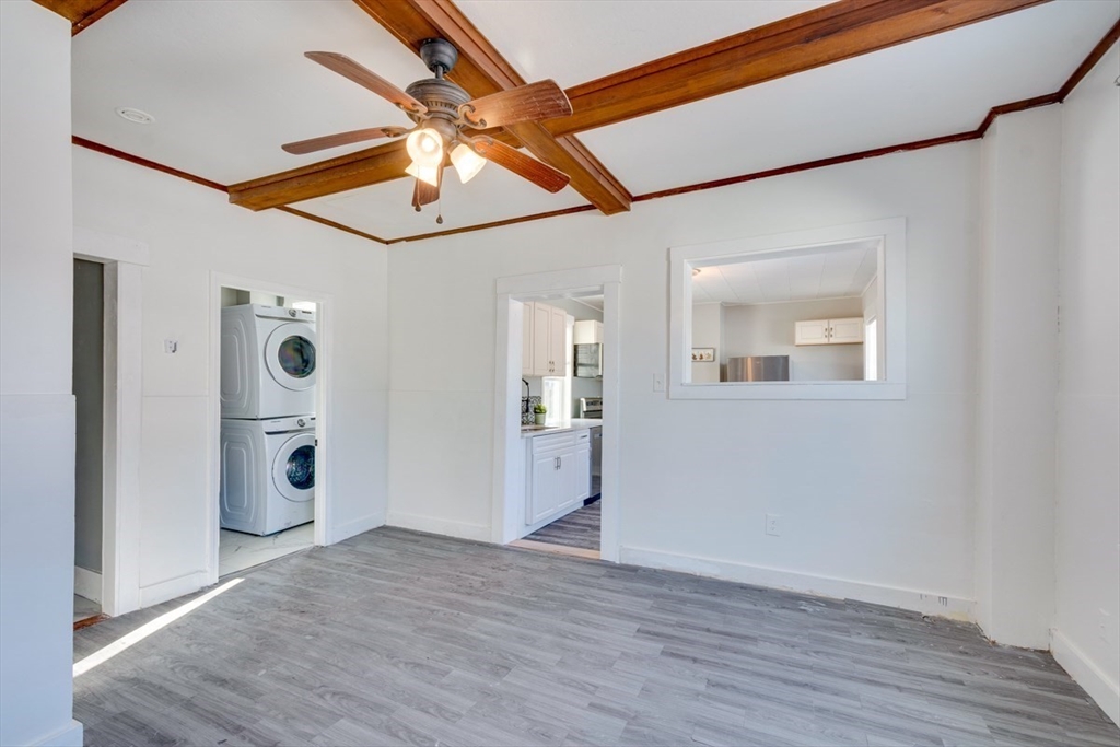 96 Pleasant Street, Unit 96 Ashland, MA 01721 - Photo 7 of 20 a view of an empty room with window and wooden floor