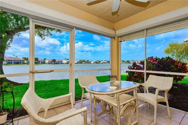 a view of a patio with a table chairs and a backyard