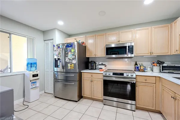 a kitchen with stainless steel appliances white cabinets and a stove top oven