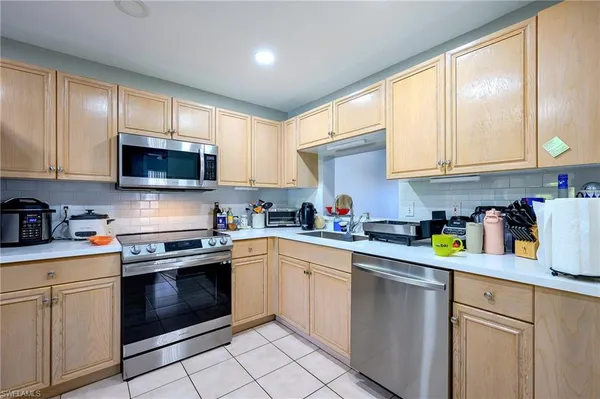 a kitchen with cabinets appliances cabinets and a sink