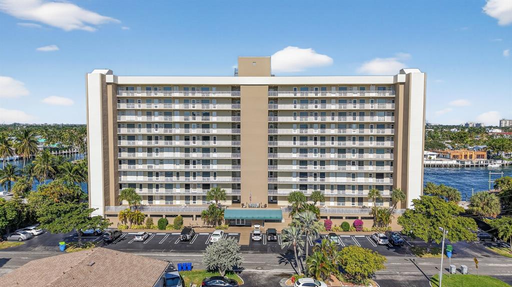 a front view of a building with a garden and plants