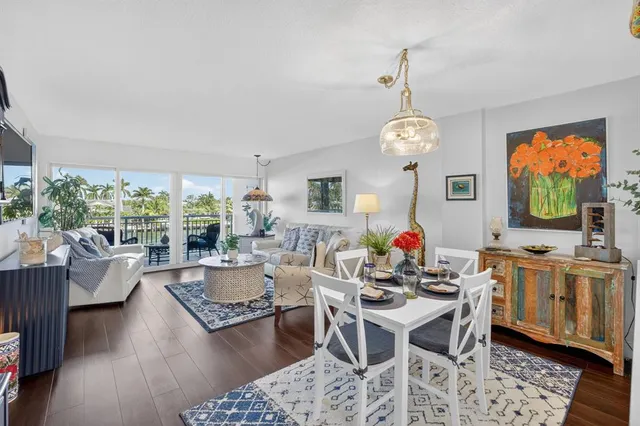 a view of a dining room with furniture a chandelier and wooden floor