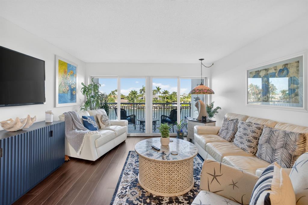 2611 North Riverside Drive, Unit 304 Pompano Beach, FL 33062 - Photo 16 of 61 a living room with furniture and a flat screen tv