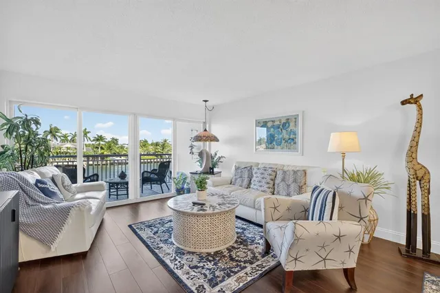 a living room with furniture a flat screen tv and a table