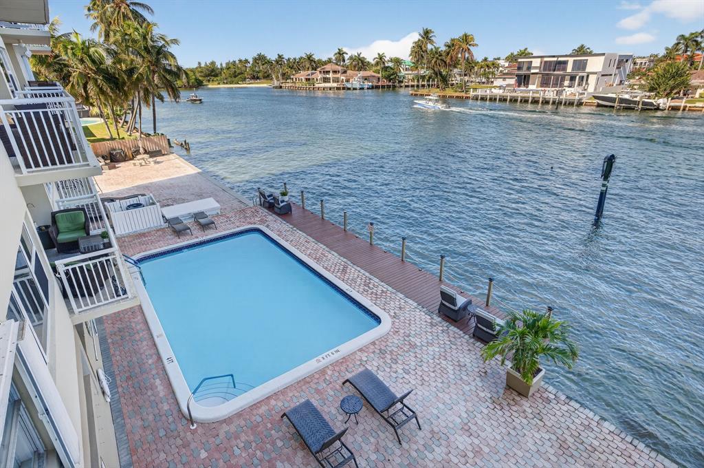 2611 North Riverside Drive, Unit 304 Pompano Beach, FL 33062 - Photo 24 of 61 a view of a terrace with lawn chairs