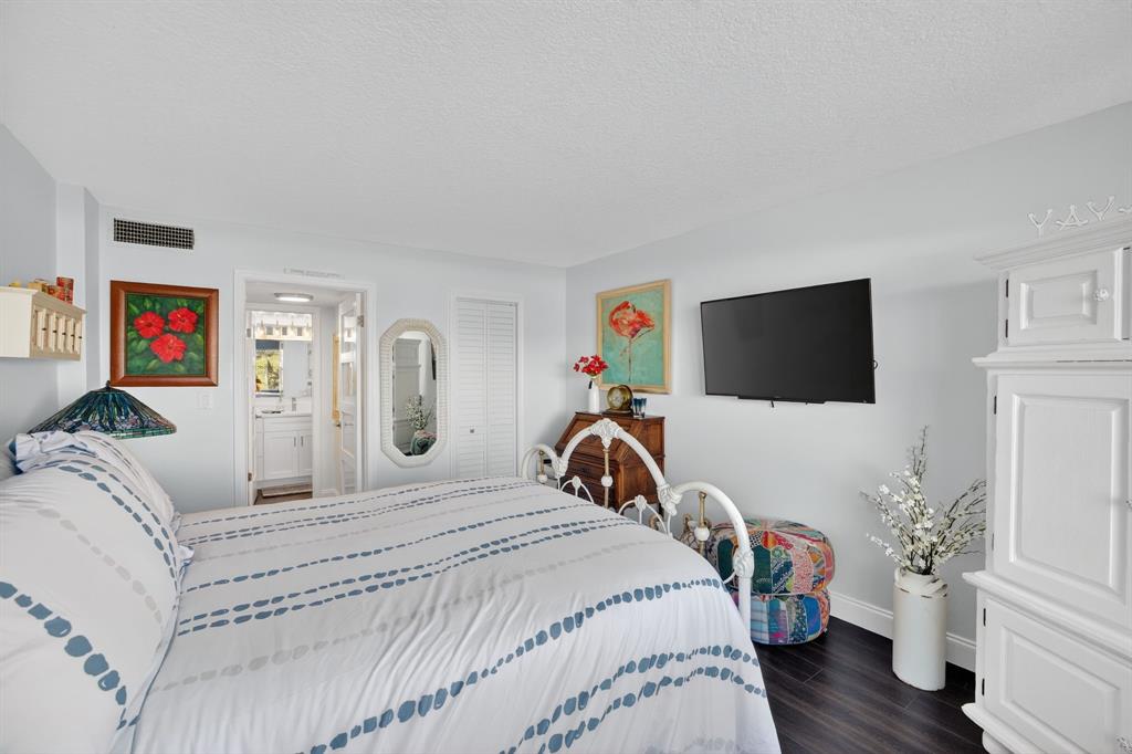 2611 North Riverside Drive, Unit 304 Pompano Beach, FL 33062 - Photo 34 of 61 a bedroom with a bed and a flat screen tv