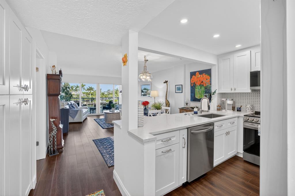 2611 North Riverside Drive, Unit 304 Pompano Beach, FL 33062 - Photo 6 of 61 a kitchen with a sink stove and cabinets
