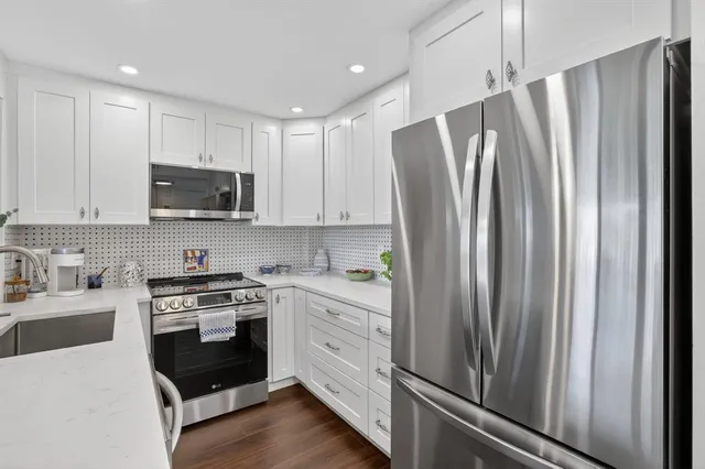 a kitchen with a sink stove and microwave