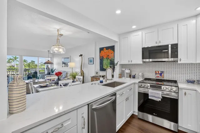 a kitchen with sink refrigerator and window