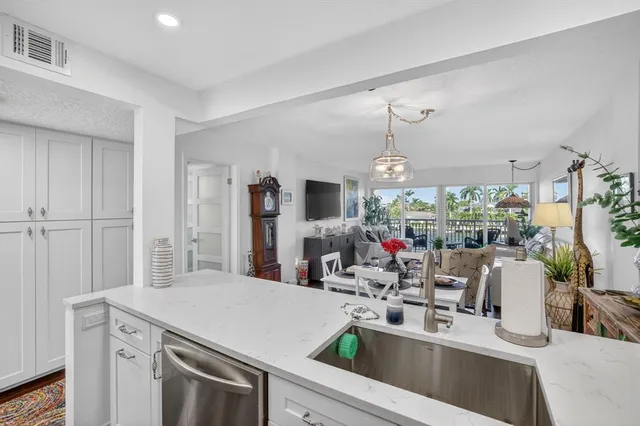 a kitchen with stainless steel appliances granite countertop a refrigerator and a sink