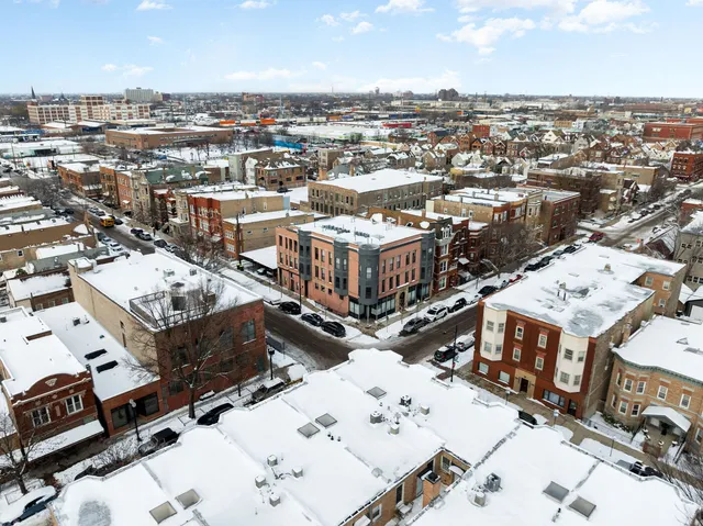 an aerial view of residential houses with city view