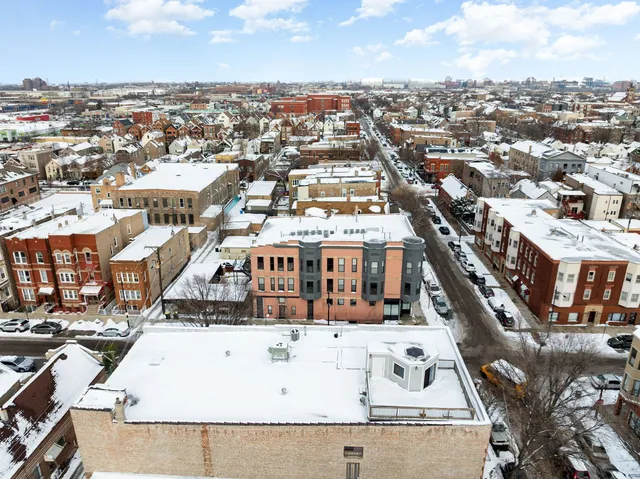 an aerial view of a house with a city view