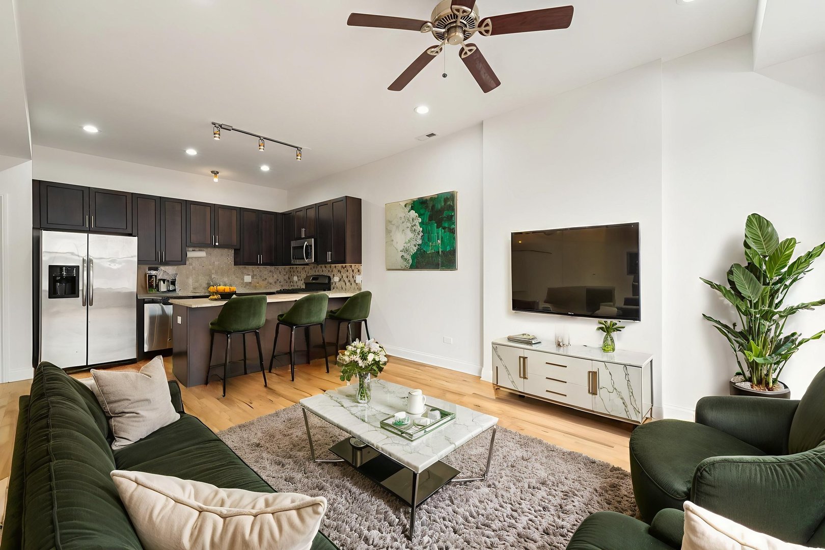 2354 South Oakley Avenue, Unit B2 Chicago, IL 60608 - Photo 5 of 25 a living room with furniture and a flat screen tv with kitchen view