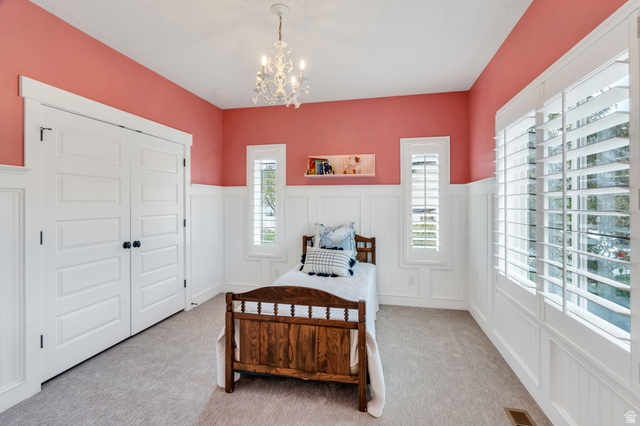 1355 West 1000 South Mapleton, UT 84664 - Photo 28 of 74 Bedroom with a decorative wall, a wainscoted wall, hanging lights, a closet, and carpet flooring