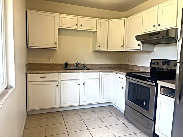 12 Pine Course Way Ocala, FL 34472 - Photo 12 of 29 a kitchen with white cabinets and appliances