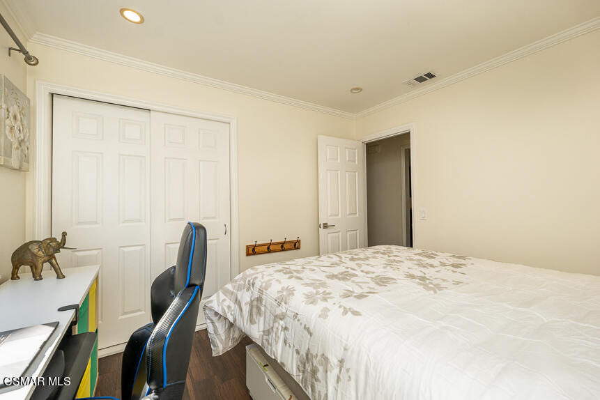13680 Bear Valley Road Moorpark, CA 93021 - Photo 15 of 50 a bedroom with a bed and a table