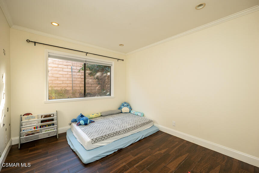 13680 Bear Valley Road Moorpark, CA 93021 - Photo 16 of 50 a bedroom with a bed and wooden floor