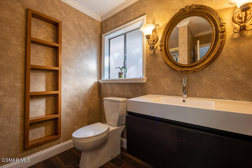 13680 Bear Valley Road Moorpark, CA 93021 - Photo 21 of 50 a bathroom with a sink a toilet and a mirror