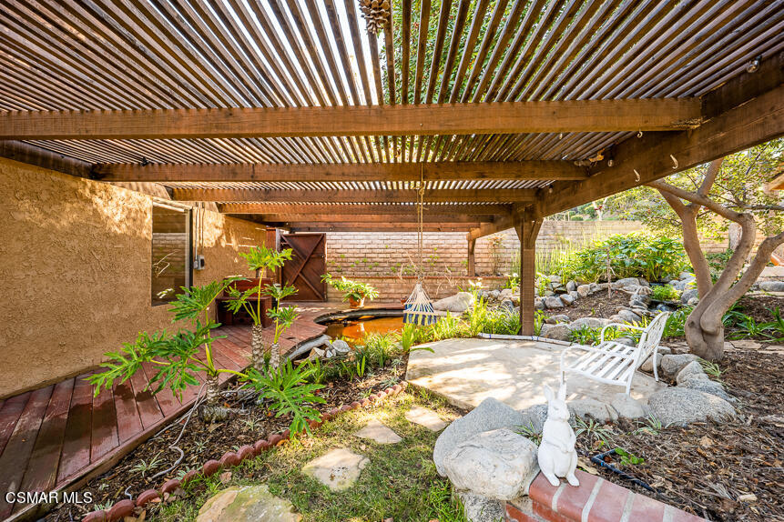 13680 Bear Valley Road Moorpark, CA 93021 - Photo 29 of 50 a view of a patio with table and chairs under an umbrella with a patio