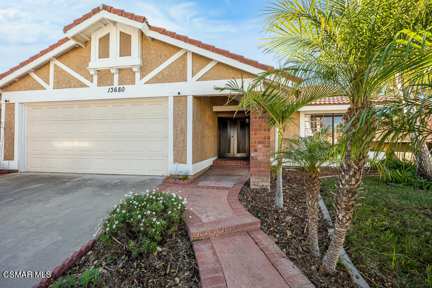 13680 Bear Valley Road Moorpark, CA 93021 - Photo 3 of 50 a front view of a house with a yard and garage