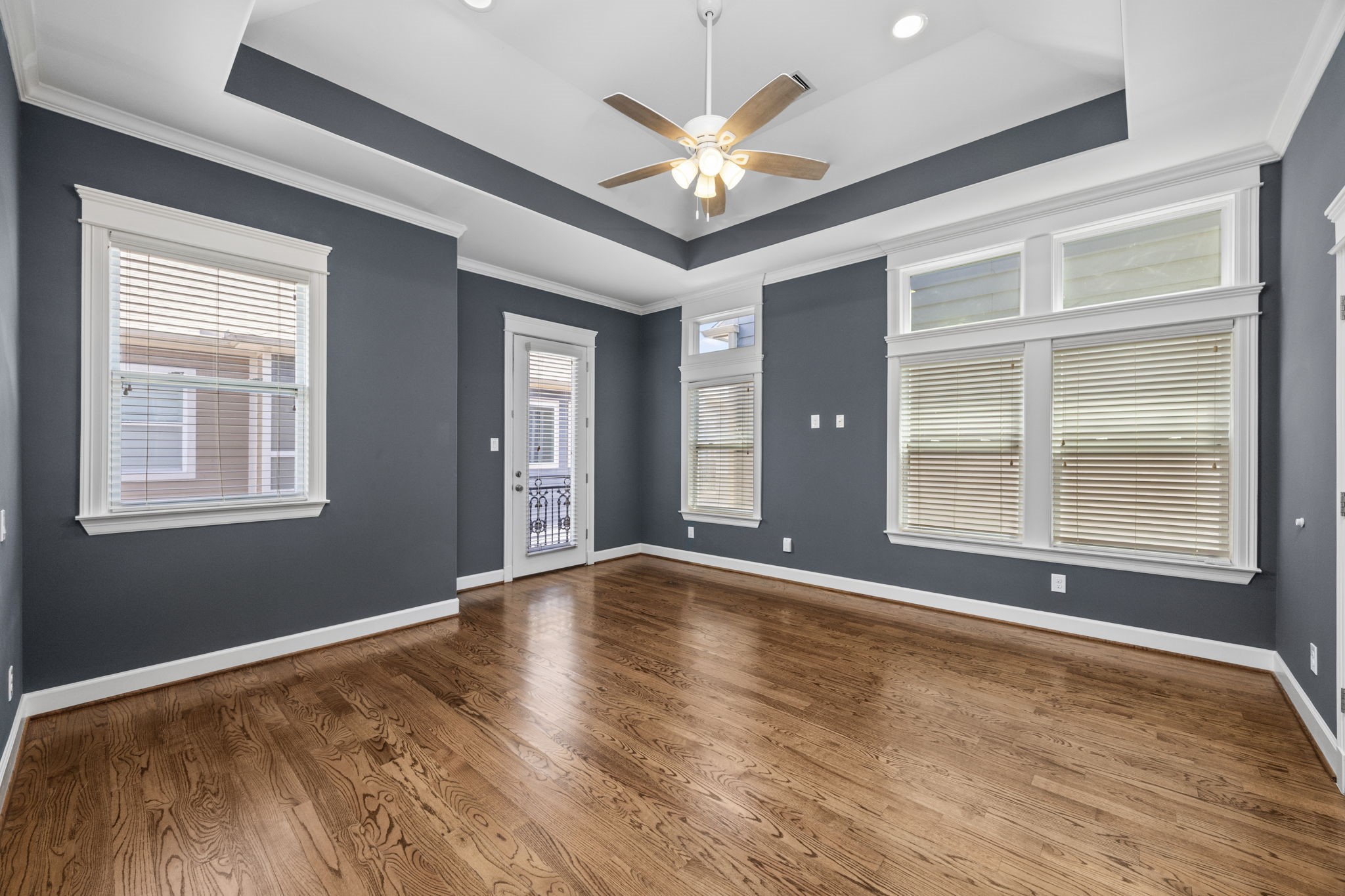 619 Rutland Street, Unit B Houston, TX 77007 - Photo 19 of 33 a view of an empty room with a window and wooden floor