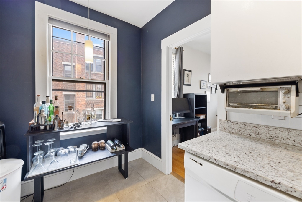 120 Sutherland Road, Unit 7 Boston, MA 02135 - Photo 12 of 25 a kitchen with a stove a refrigerator and a window