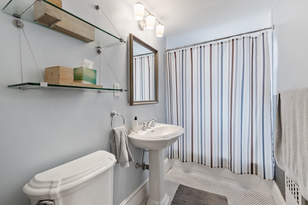 120 Sutherland Road, Unit 7 Boston, MA 02135 - Photo 16 of 25 a bathroom with a sink a toilet and mirror