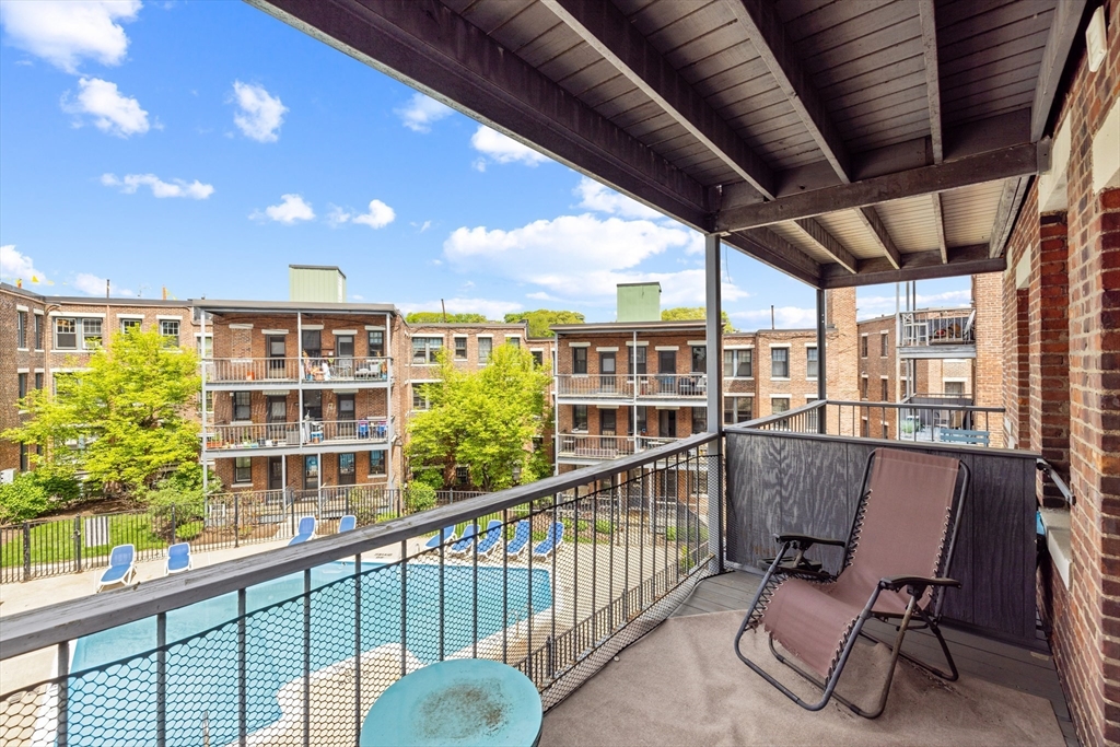 120 Sutherland Road, Unit 7 Boston, MA 02135 - Photo 22 of 25 a view of a chairs and table in a balcony