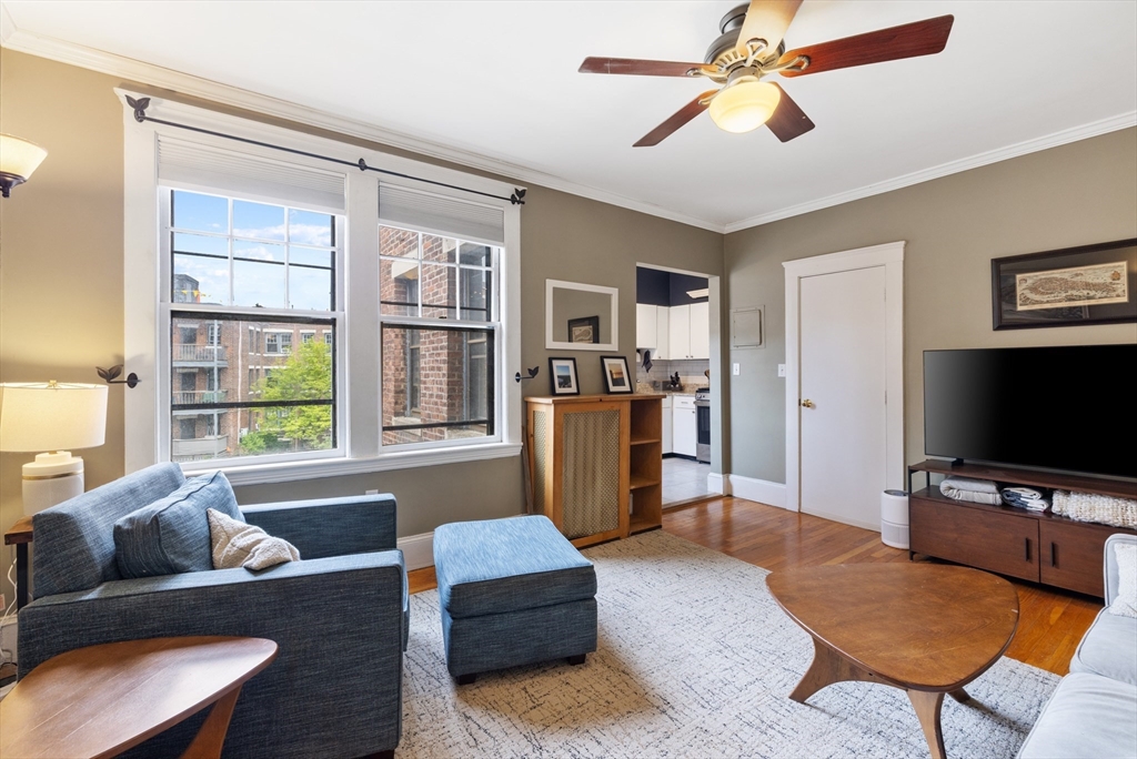 120 Sutherland Road, Unit 7 Boston, MA 02135 - Photo 3 of 25 a living room with furniture and a flat screen tv