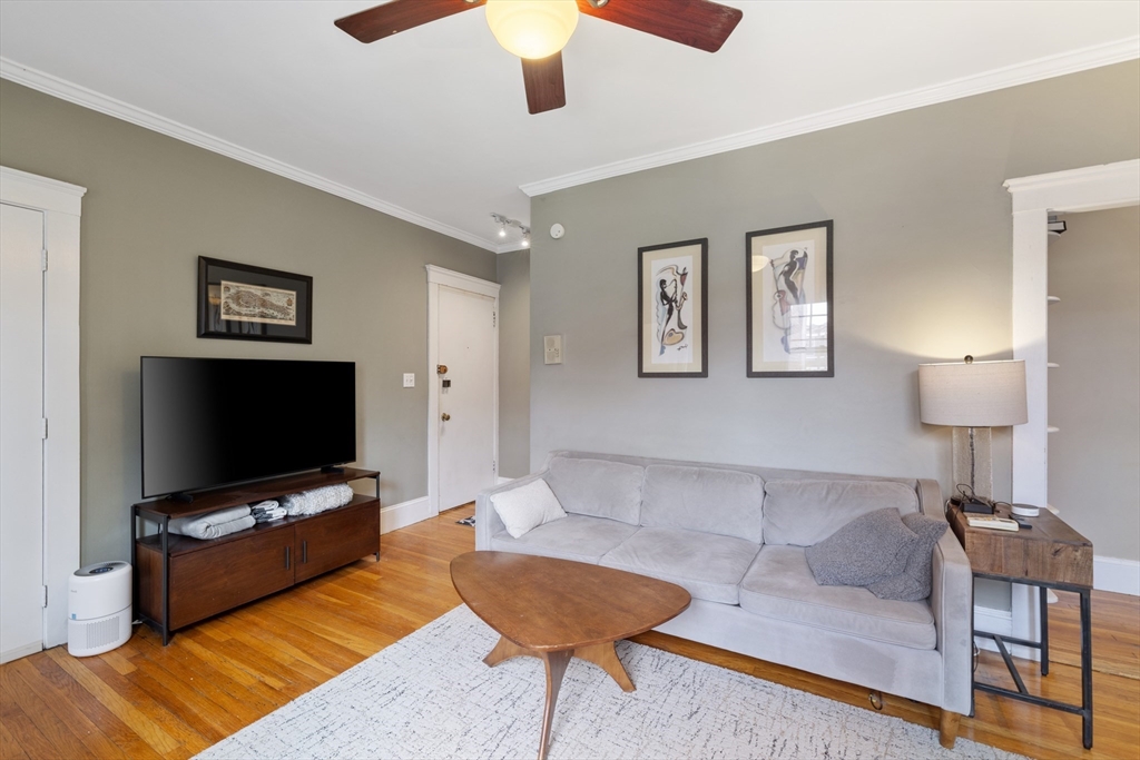 120 Sutherland Road, Unit 7 Boston, MA 02135 - Photo 4 of 25 a living room with furniture and a flat screen tv