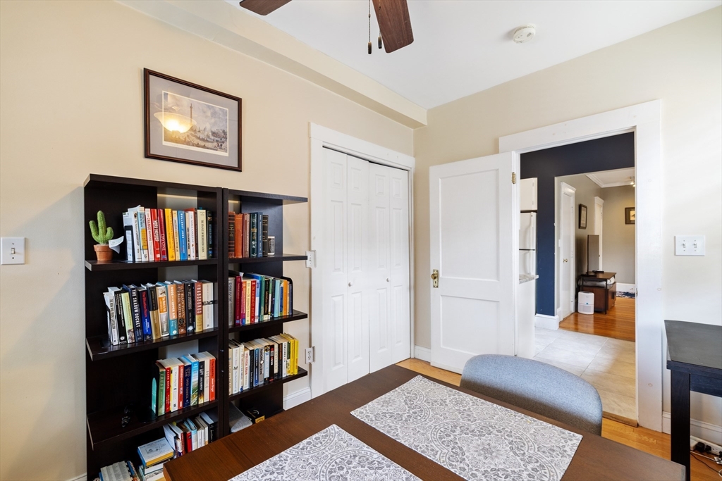 120 Sutherland Road, Unit 7 Boston, MA 02135 - Photo 6 of 25 a bedroom with furniture and a book shelf