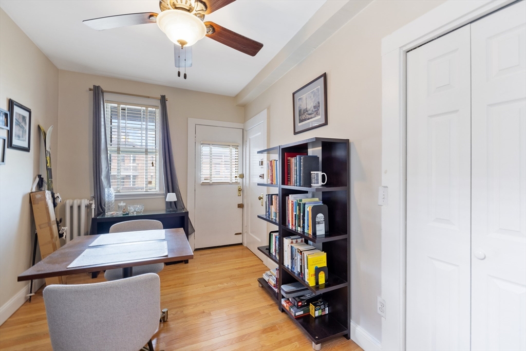 120 Sutherland Road, Unit 7 Boston, MA 02135 - Photo 7 of 25 a living room with furniture and a book shelf