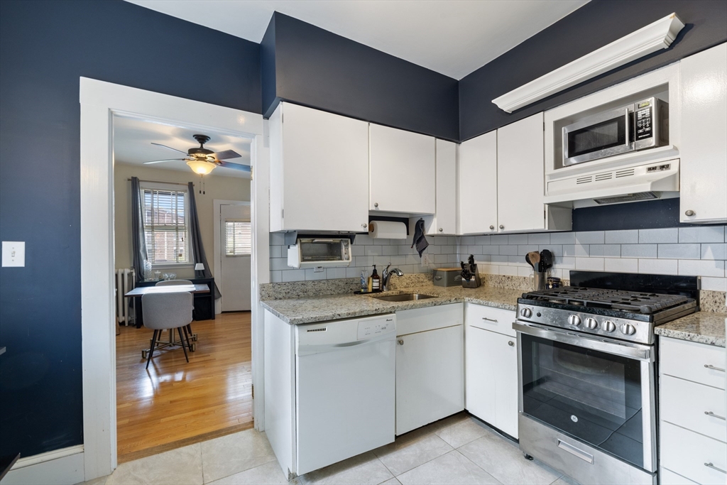 120 Sutherland Road, Unit 7 Boston, MA 02135 - Photo 9 of 25 a kitchen with a stove and a microwave