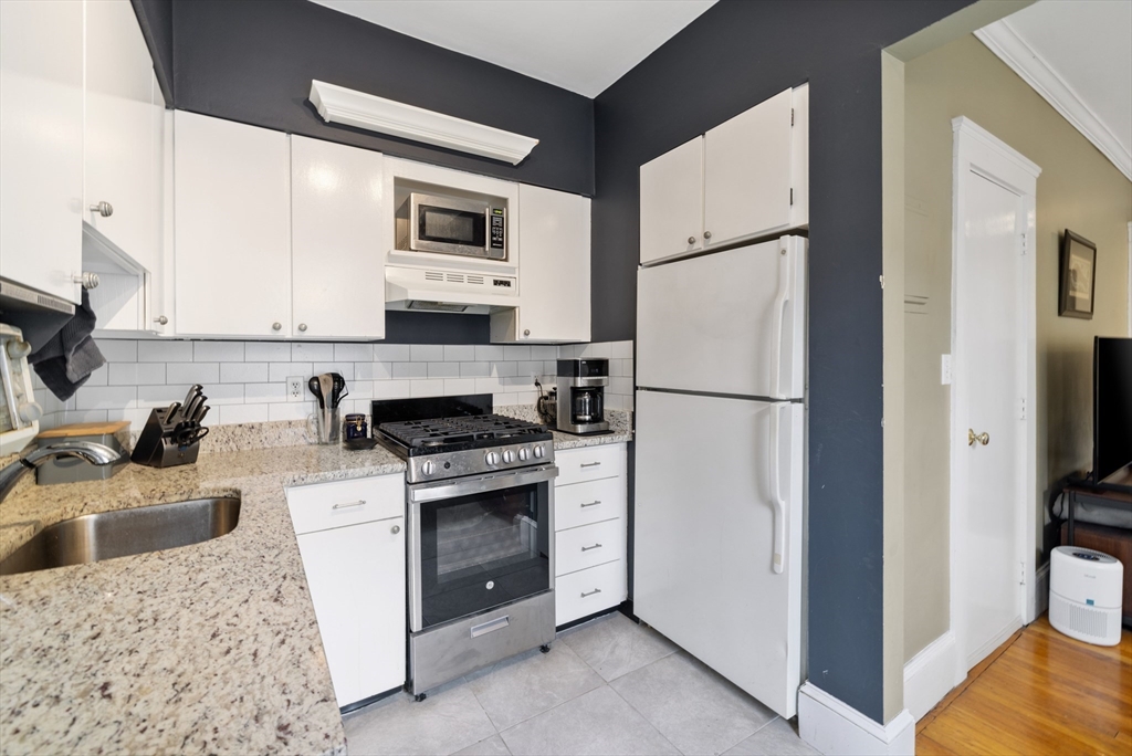 120 Sutherland Road, Unit 7 Boston, MA 02135 - Photo 10 of 25 a kitchen with a refrigerator stove and sink