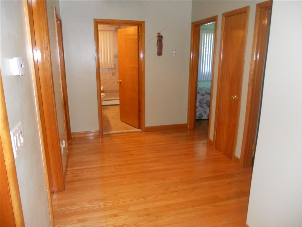 12 Lawrence Road North Providence, RI 02911 - Photo 12 of 40 EXTRA WIDE OAK HARDWOOD HALLWAY- A UNIQUE FEATURE LARGE 10 FOOT X 7 +1/2 FOOT WIDE HALL WAY AT BEDROOM AND BATHROOM HALLWAY.THE HALLWAY CLOSET IS ALSO A BONUS.