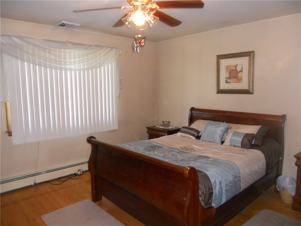 12 Lawrence Road North Providence, RI 02911 - Photo 13 of 40 12 + 1/2 FOOT X 13 +1/4 FOOT, MASTER BEDROOM, WITH 
 OAK FLOORING AND A 6 +1/2 FOOT OAK FLOORED SLIDING DOOR CLOSET. CEILING FAN INCLUDED, 3 PANE-CASEMENT WINDOW